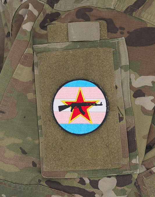 Three inch velcro patch. The Trans flag with a red star and an AK-47