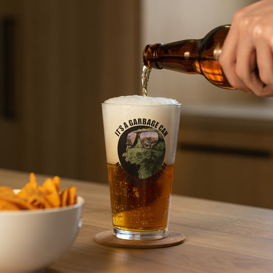 Pint Glass with circle lettering reading It's a  Garbage Can, not a Garbage Cannot in a circle. with Oscar the grouch in the center.