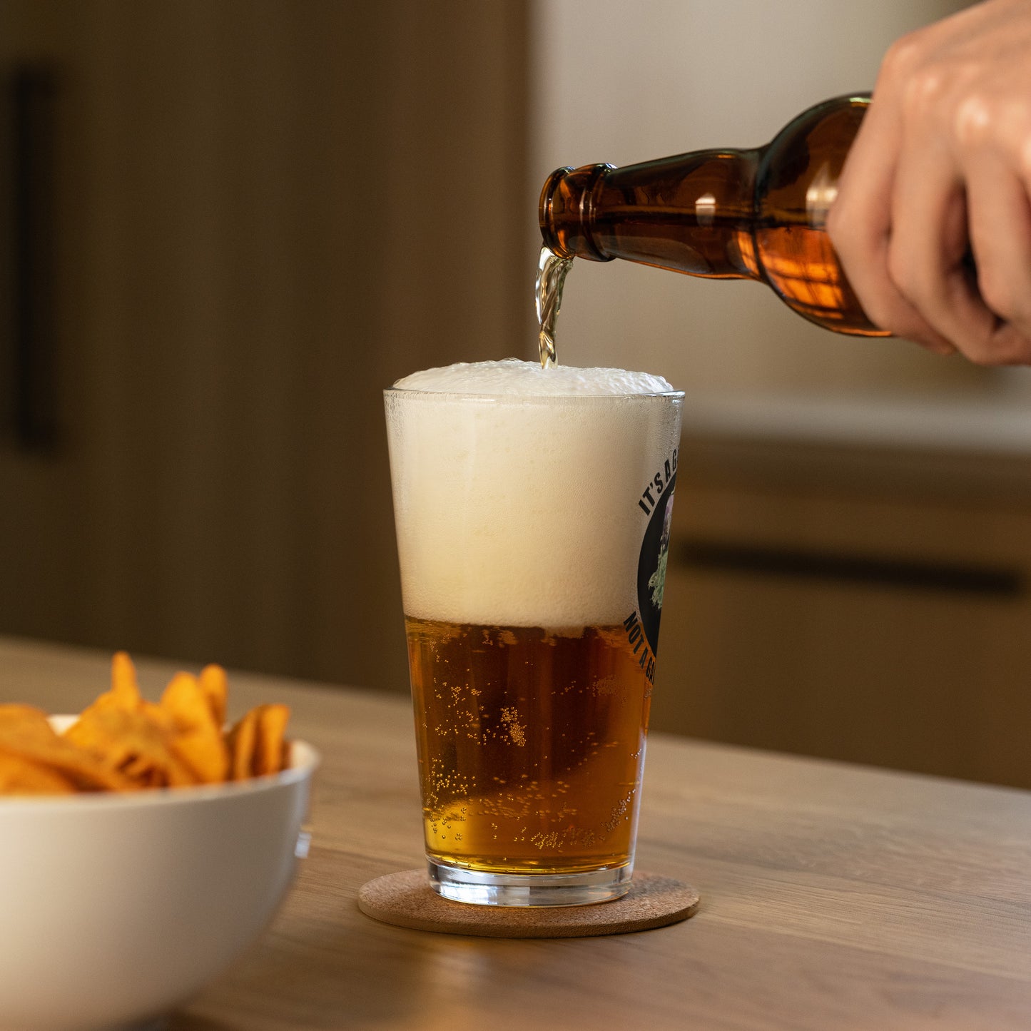 Pint Glass with circle lettering reading It's a  Garbage Can, not a Garbage Cannot in a circle. with Oscar the grouch in the center.