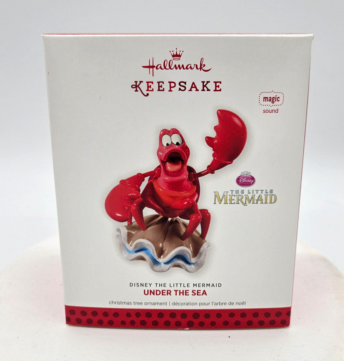 Hallmark Keepsake ornament packaging featuring a red crab character from 'The Little Mermaid'.