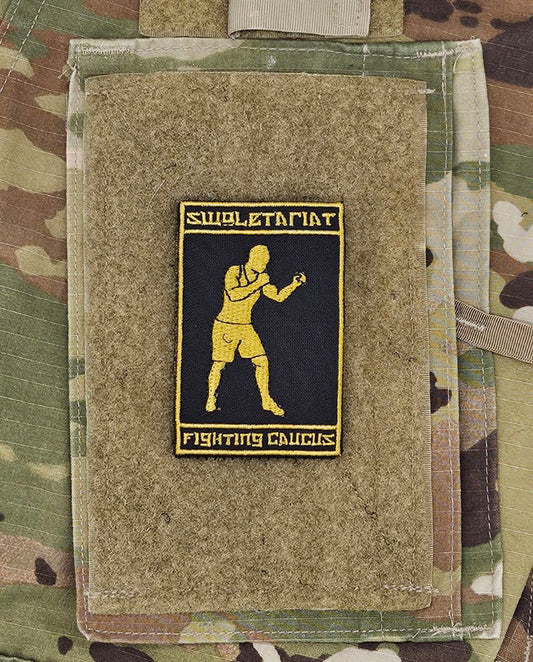 Patch with a boxing illustration on a camouflage background. Above says Swoletariat and below says Fighting Caucus
