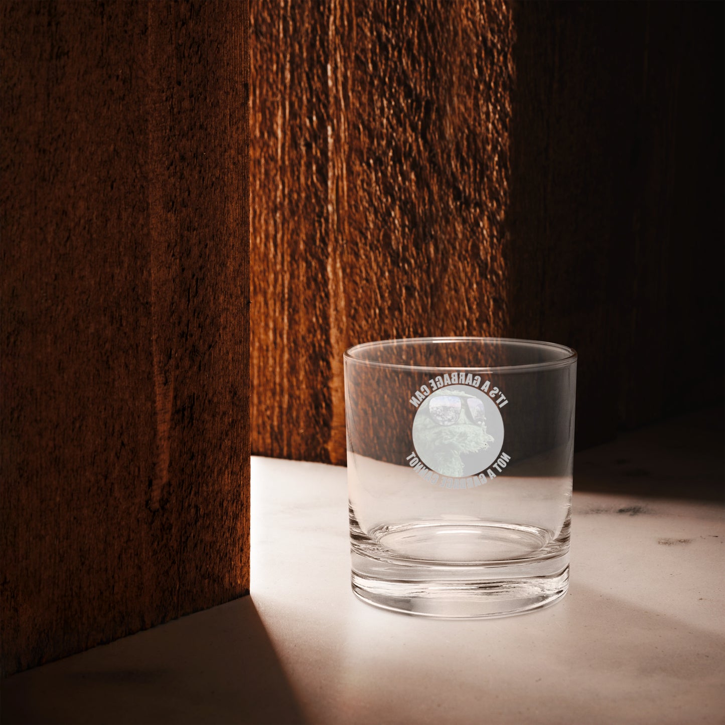 Rocks glass with circle lettering reading It's a  Garbage Can, not a Garbage Cannot in a circle. with Oscar the grouch in the center. 