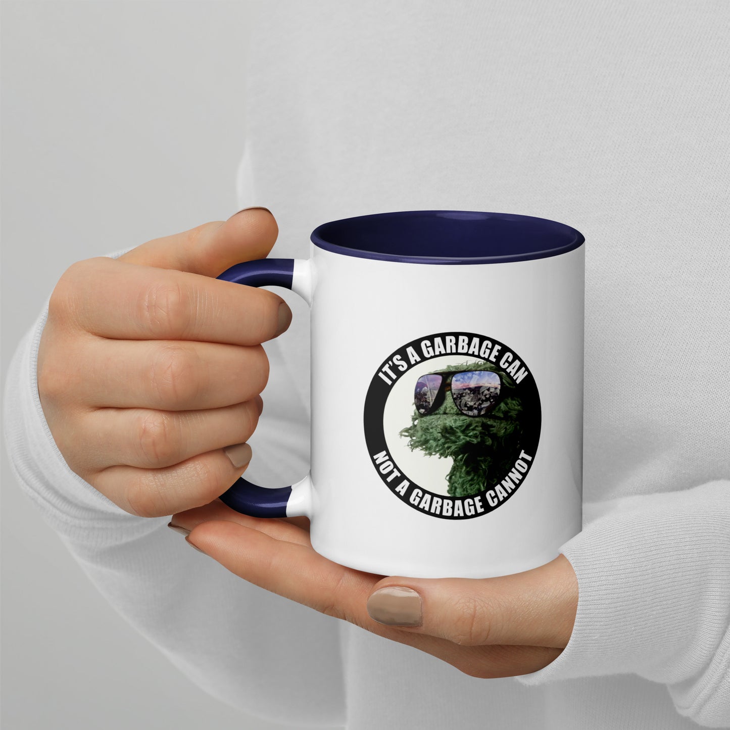 Coffee Mug white outside and Blue interior with It's a Garbage Can, not a Garbage Cannot in a circle. with Oscar the grouch in the center. 