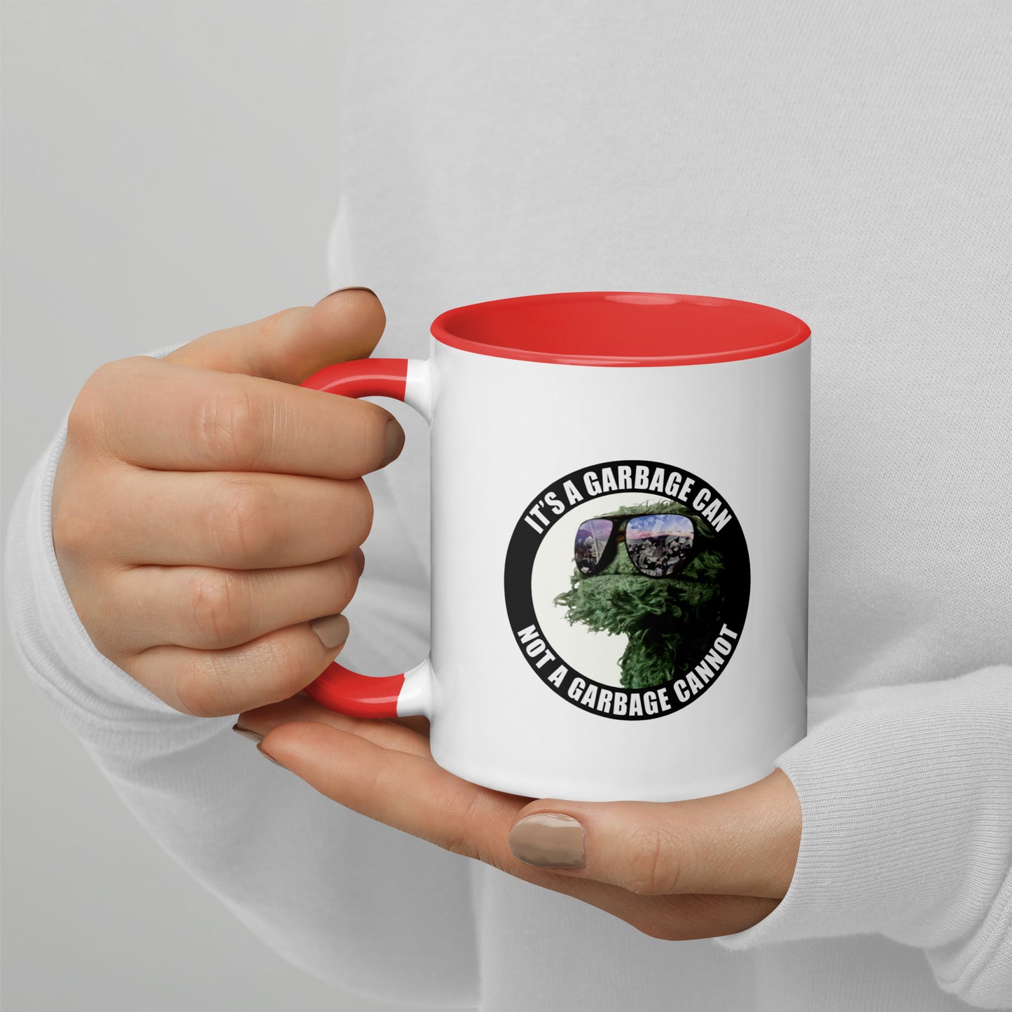 Coffee Mug white outside and red interior with It's a Garbage Can, not a Garbage Cannot in a circle. with Oscar the grouch in the center. 
